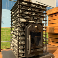 Outdoor wood stove with stone chimney in a garden setting