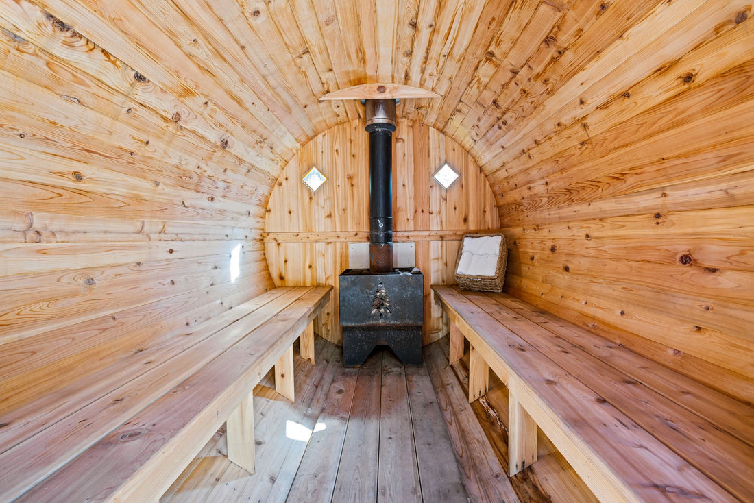 Interior of a cedar barrel sauna with a wood-burning heater