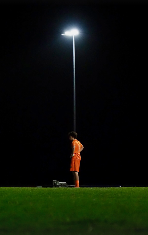 Athlete training alone at night, representing the unseen work behind success.