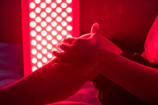 Red light therapy panel emitting deep red light for skin and recovery.