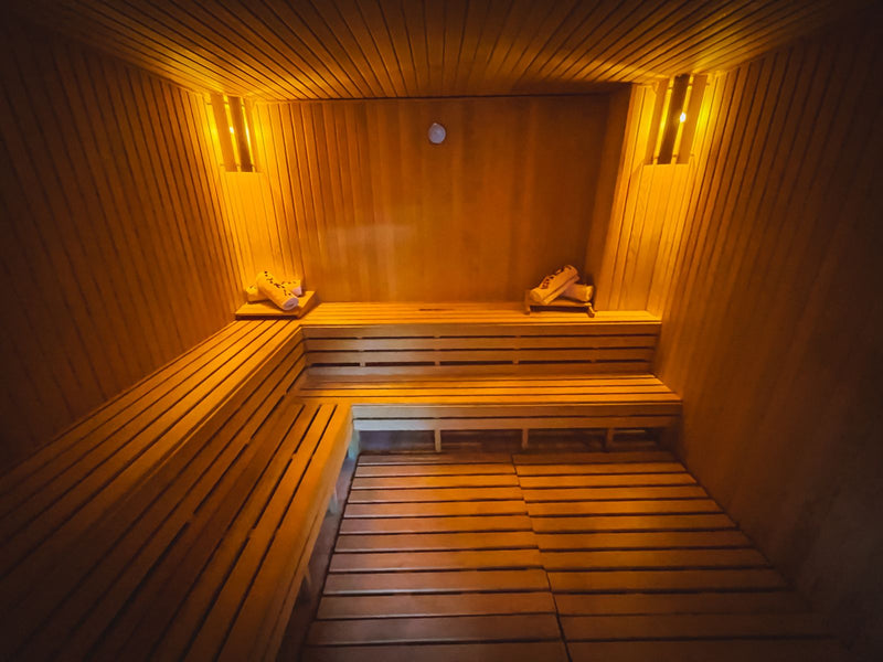 Cozy wooden sauna interior with warm lighting.