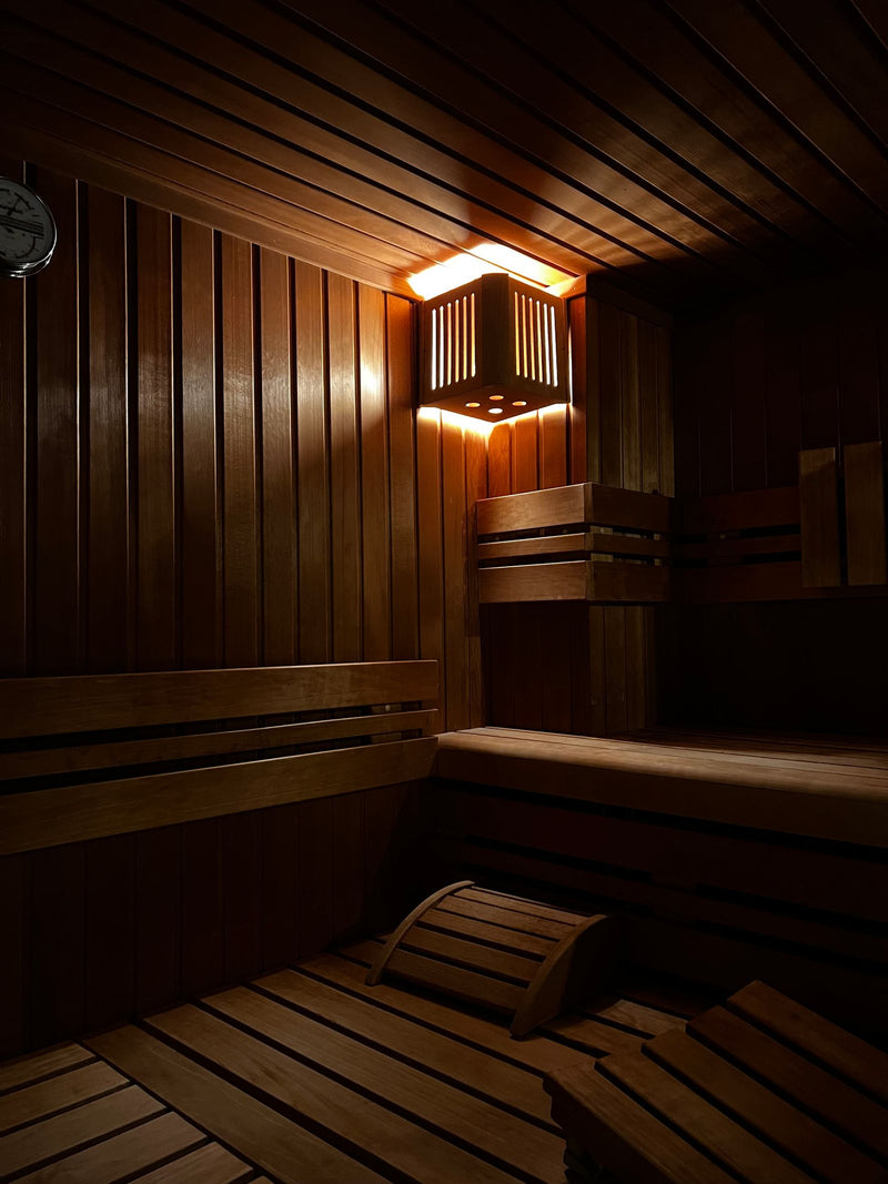 Cozy wooden sauna interior with warm lighting in a calm home wellness space.
