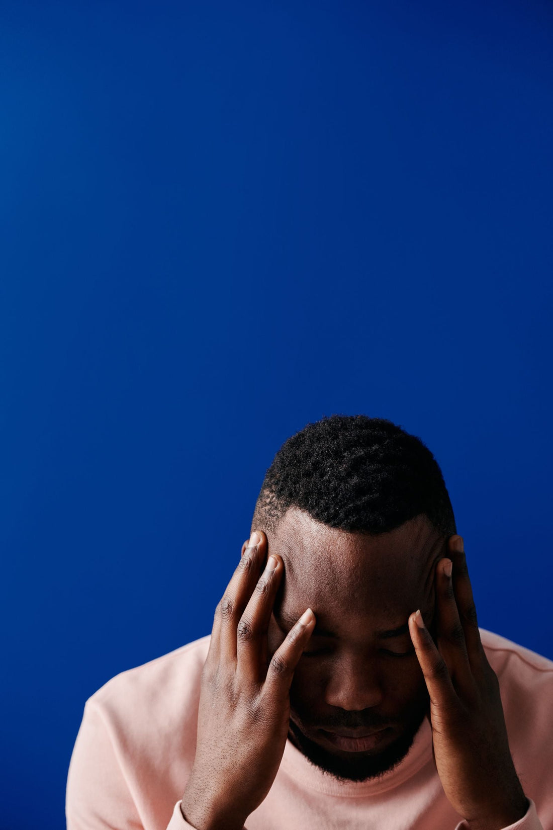 Person in a quiet, reflective moment, representing sauna and mental wellbeing.