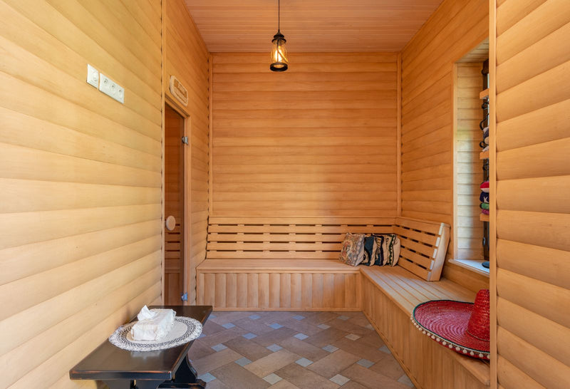 Calm, warm sauna interior with wooden benches — a quiet space for relaxation.
