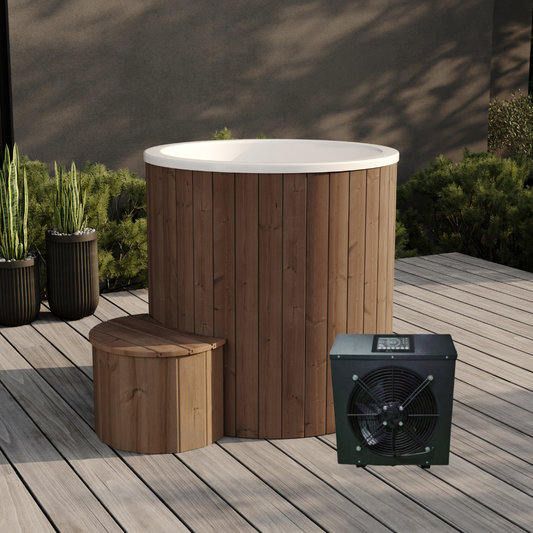 Compact single-person ice bath installation on an outdoor wooden deck, featuring a brown wooden exterior, a white insulated top, and including a black high-performance chiller.